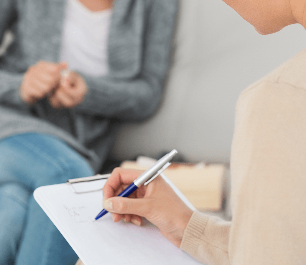 therapist writing notes her clipboard